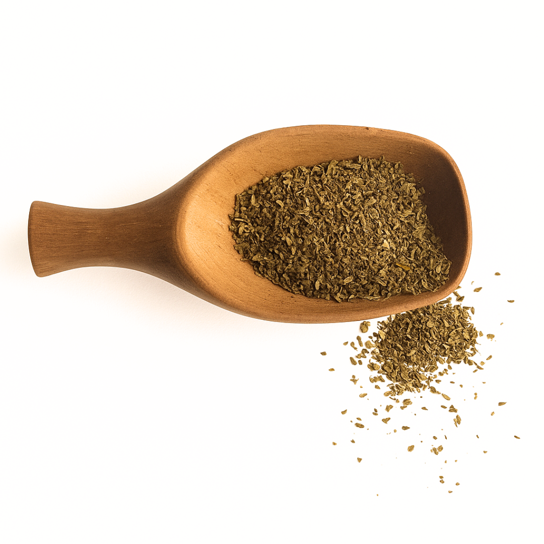 Wooden spoon filled with dried herbs on a white background