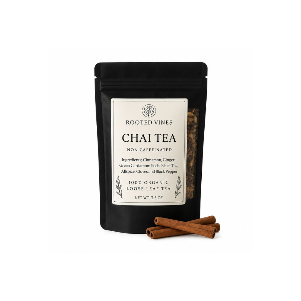 A black stand-up pouch of Rooted Vines Chai Tea with a cream label, shown on a white background with three cinnamon sticks in front.