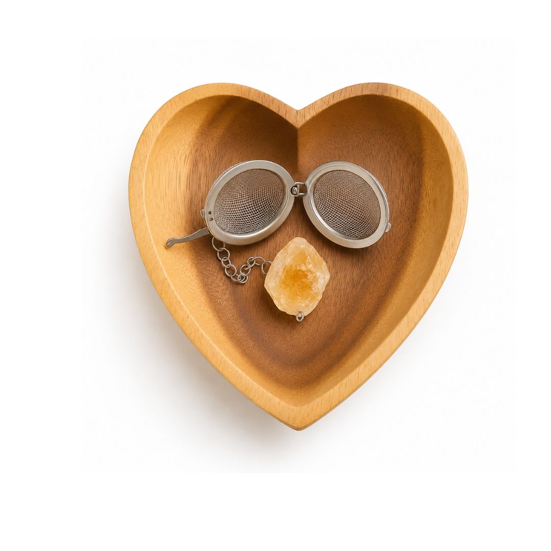 Heart-shaped wooden dish with a Citrine gem tea infuser and crystal on a white background