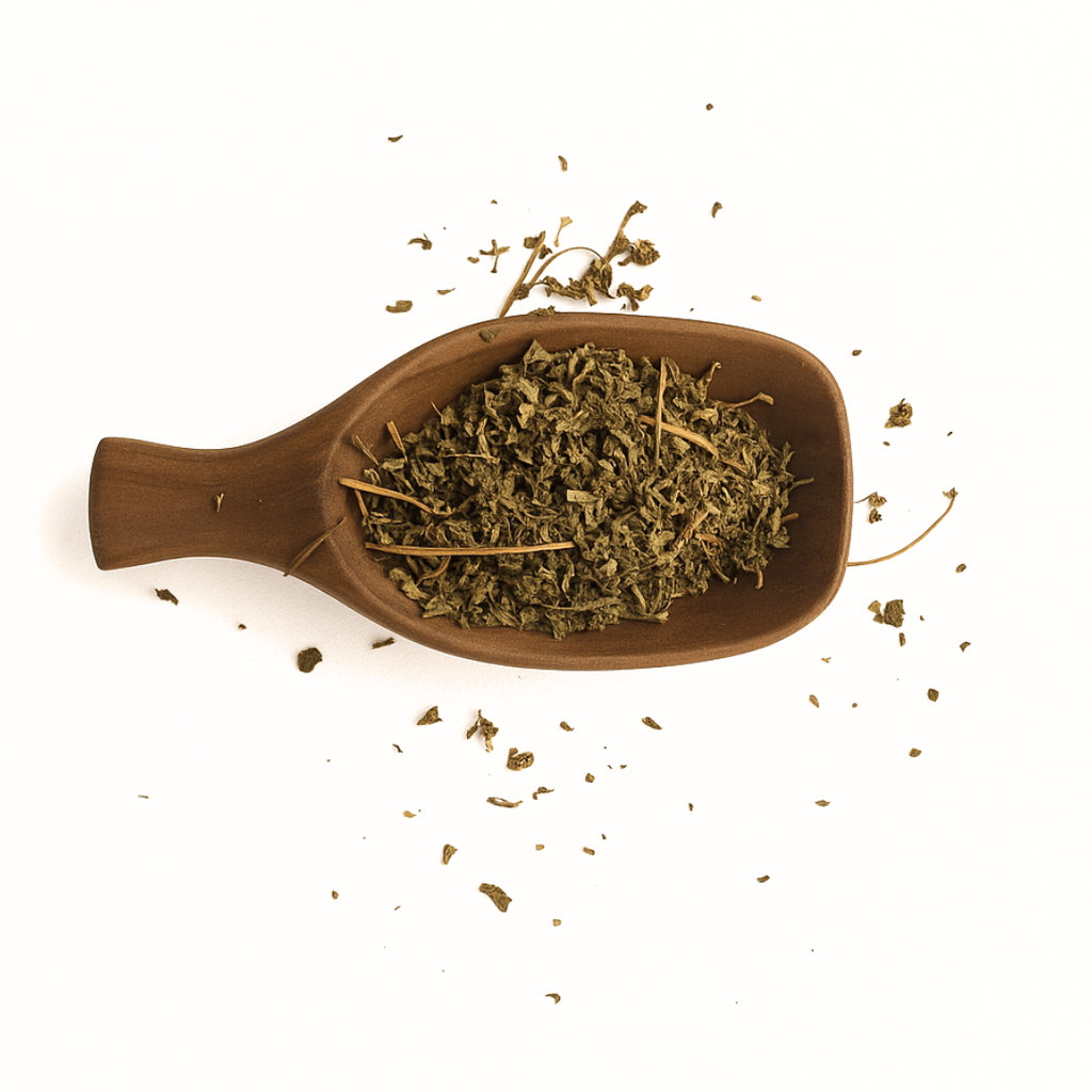 Wooden spoon filled with dried herbs on a white background