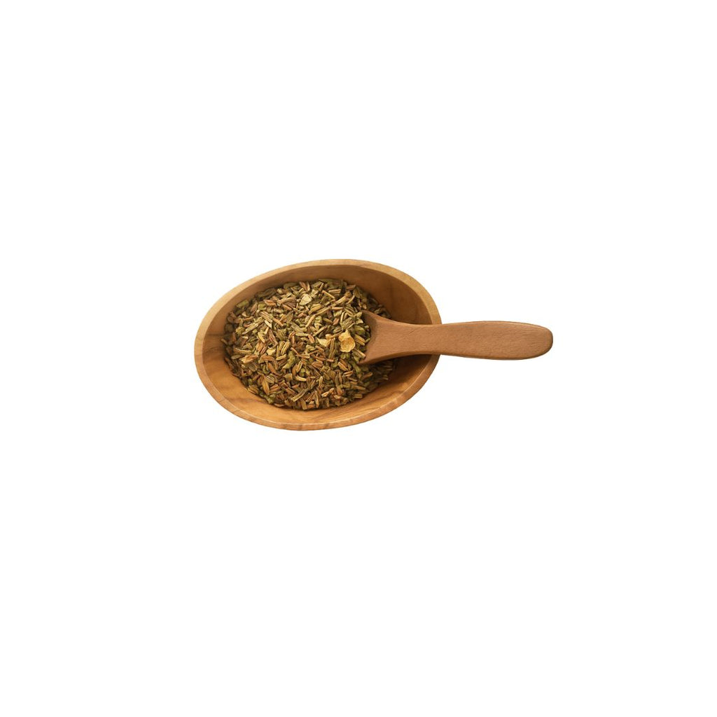 Wooden scoop filled with dried herbs on a white background