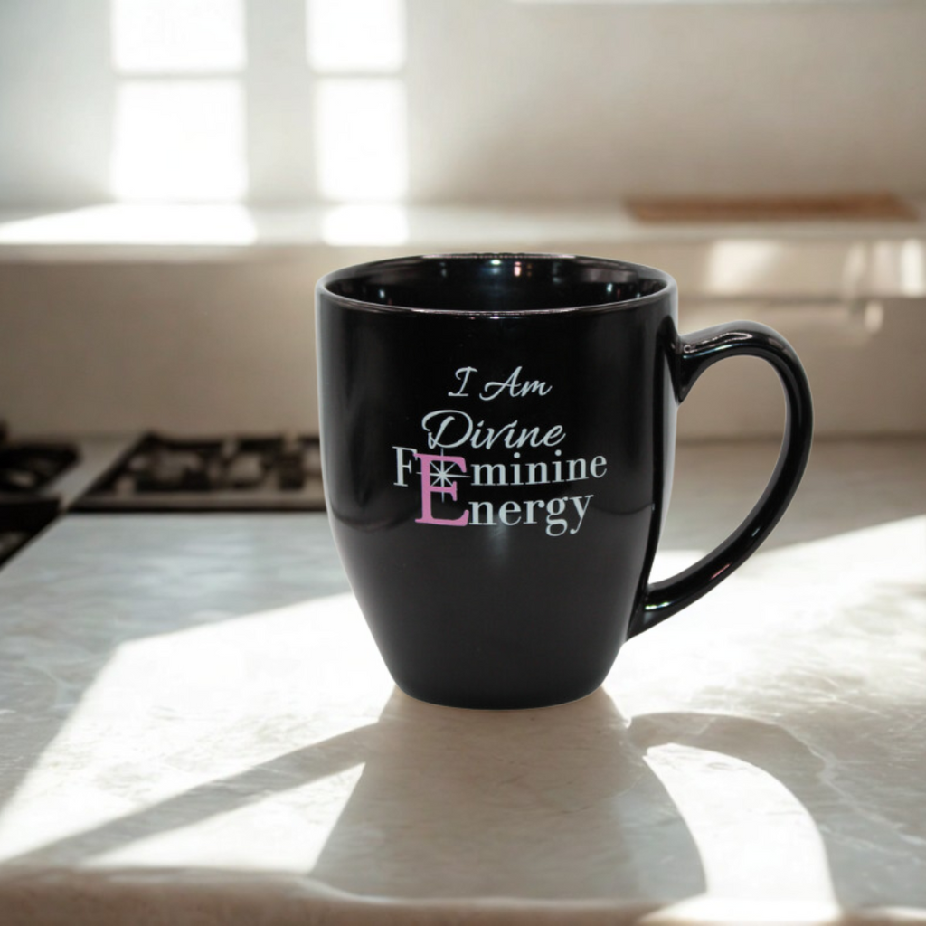 Black mug with 'I Am Divine Feminine Energy' text on a kitchen counter