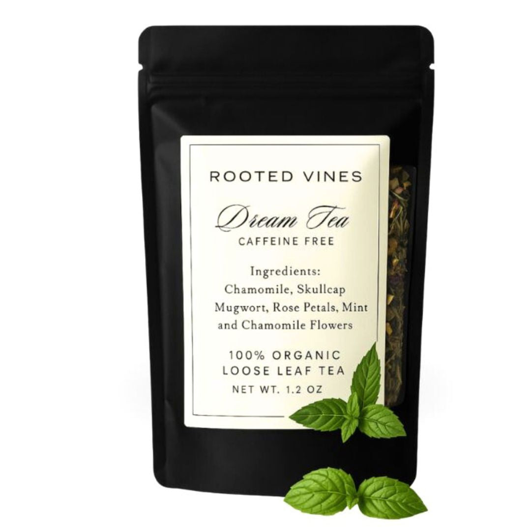 Black package of Rooted Vines Dream Tea with a label and mint leaves on a white background