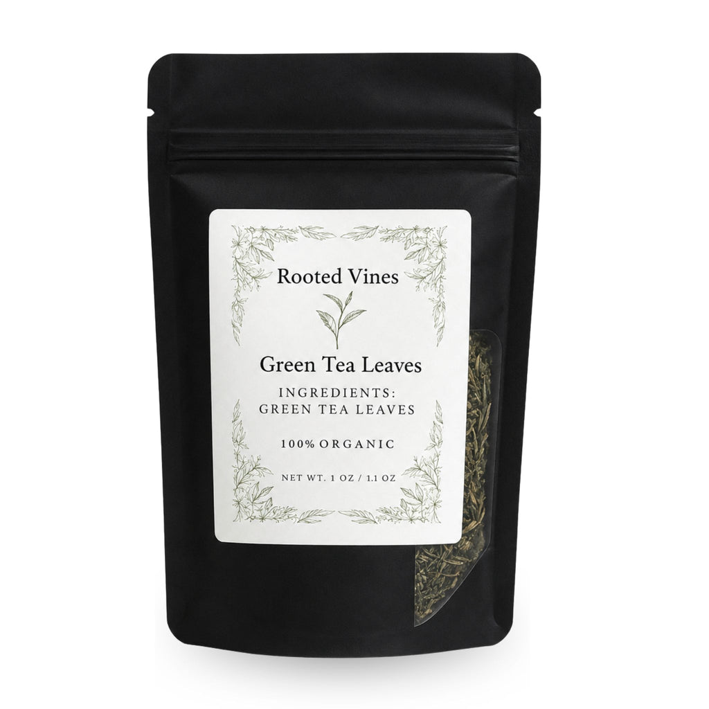 A black stand-up pouch of Rooted Vines Green Tea Leaves on a white background, featuring a white label with green botanical illustrations and a clear window showing the tea leaves inside.