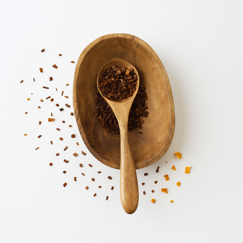 Wooden spoon and bowl with dried herbs on a white background