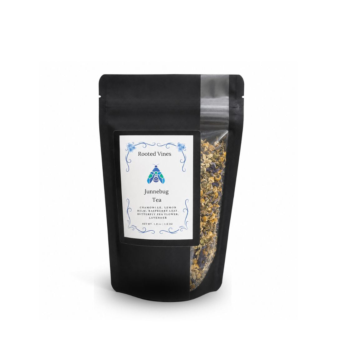 A black stand-up pouch of Rooted Vines Junnebug Tea with a white label and a clear window showing the loose tea inside, set against a plain white background.