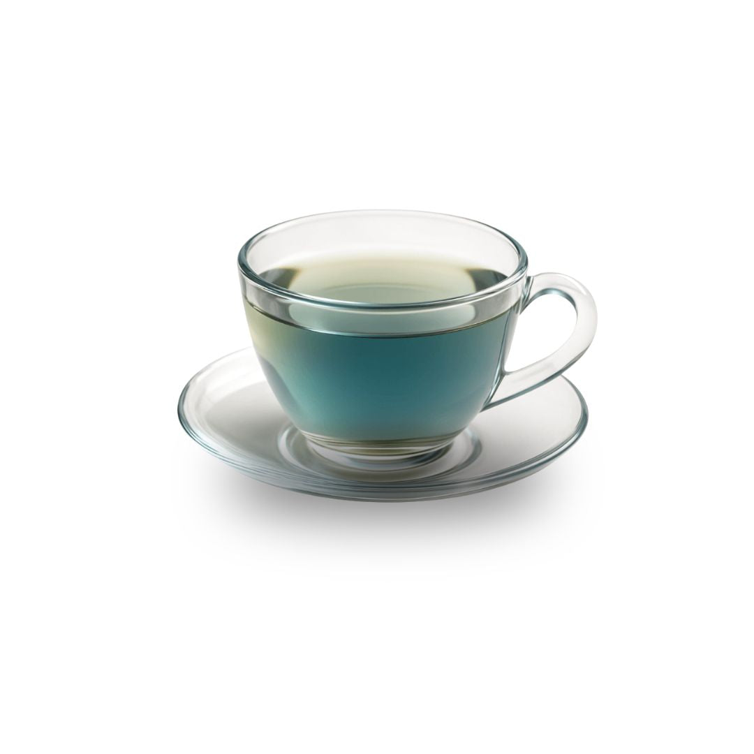Clear glass teacup with blue liquid on a white background