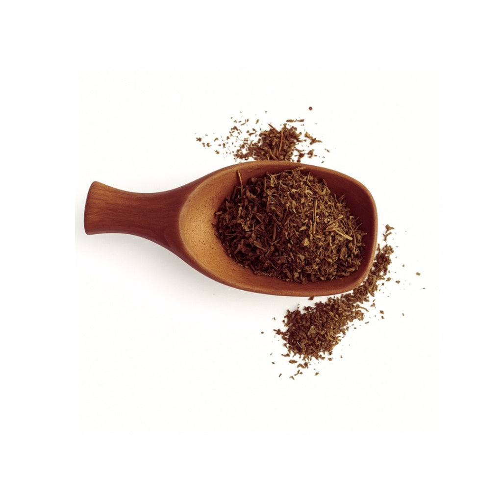 Wooden scoop filled with dark brown leafy substance on a white background