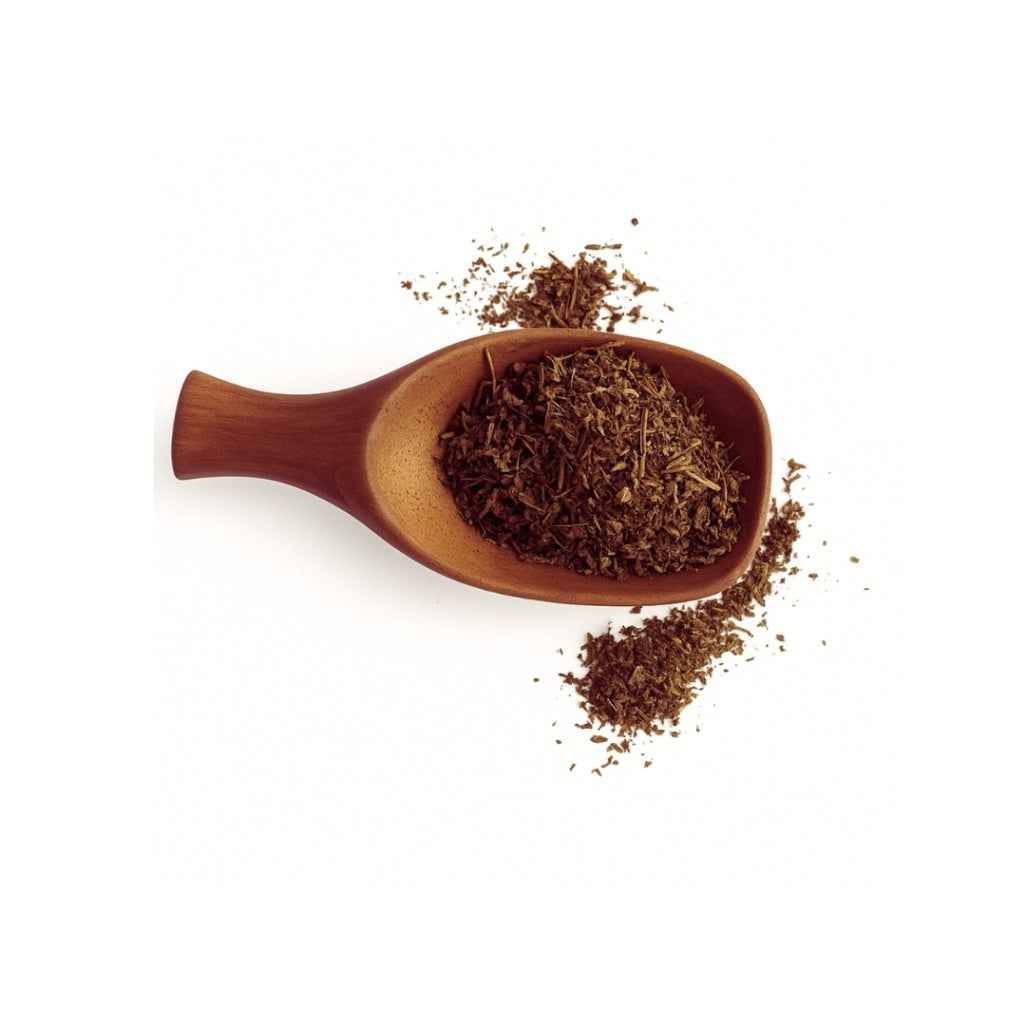 Wooden scoop filled with dark brown leafy substance on a white background