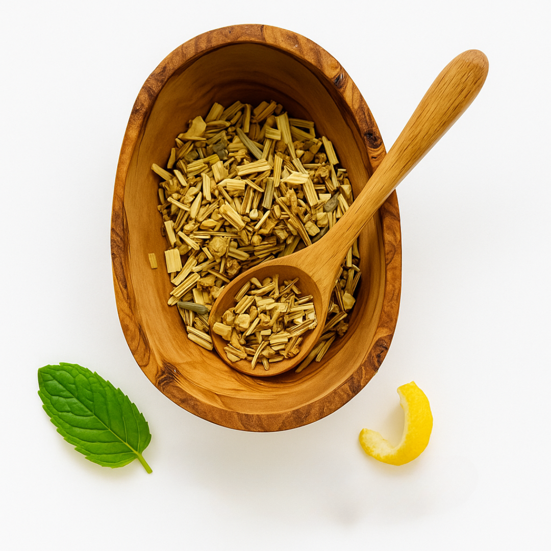 Wooden bowl with dried herbs, a wooden spoon, a mint leaf, and a lemon wedge on a white background.