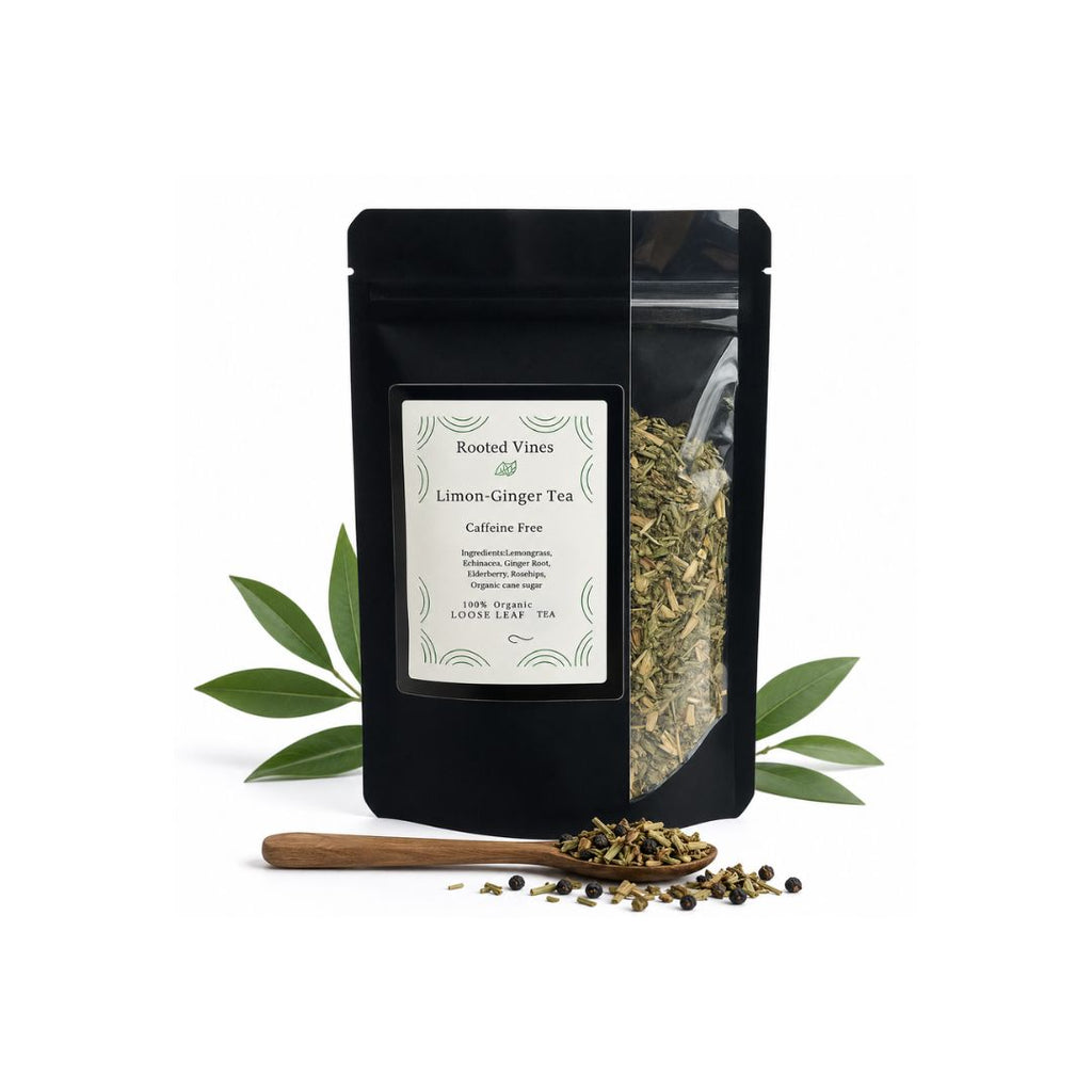 A black stand-up pouch of Rooted Vines Lemon Ginger Tea with a white label, displayed on a white background with green leaves and a wooden spoon containing loose tea.