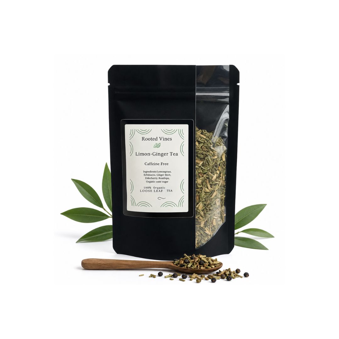 A black stand-up pouch of Rooted Vines Lemon Ginger Tea with a white label, displayed on a white background with green leaves and a wooden spoon containing loose tea.