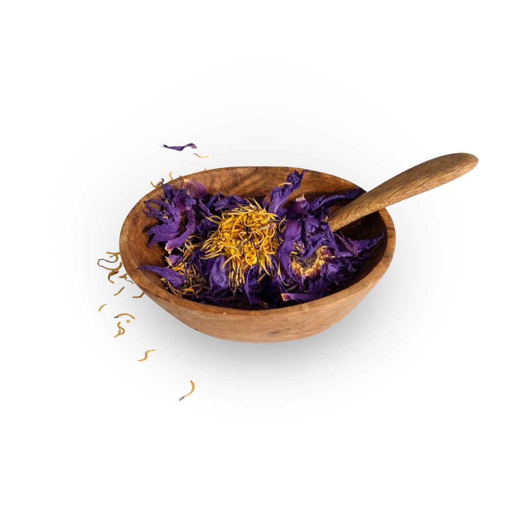 Wooden bowl with dried purple and yellow flowers and a wooden spoon on a white background