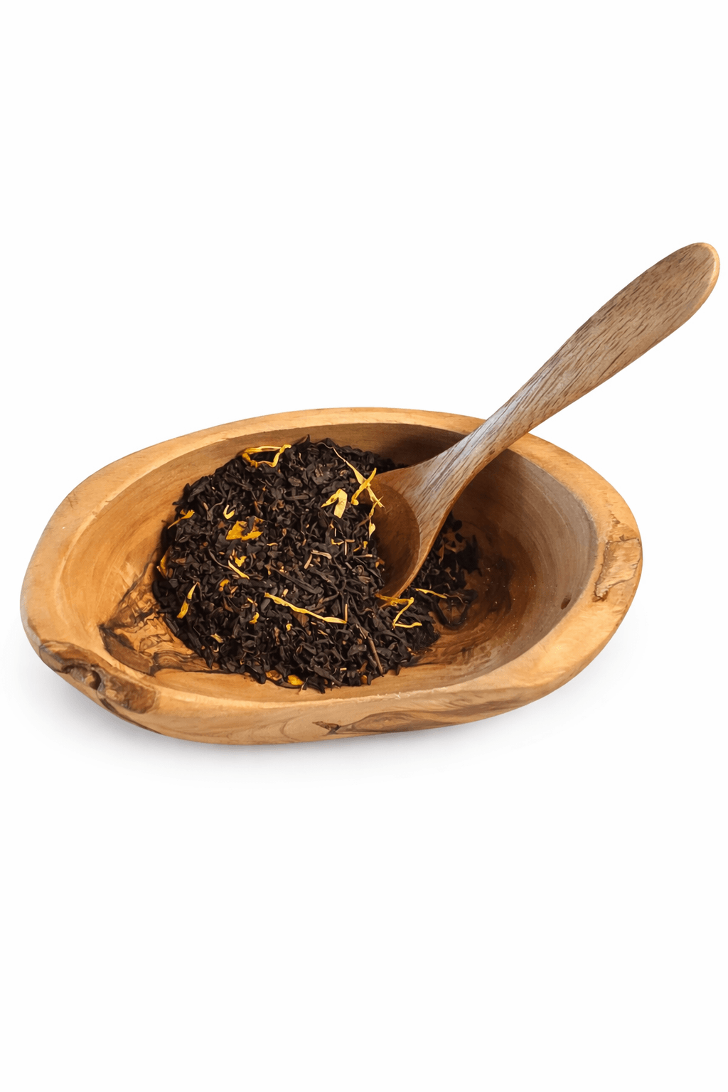 Wooden bowl with tea leaves and a wooden spoon on a white background