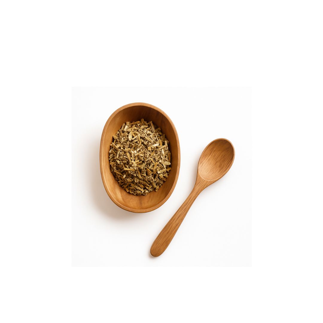 A small oval wooden bowl filled with dried herb or tea leaves, placed next to a matching wooden spoon on a clean white background.