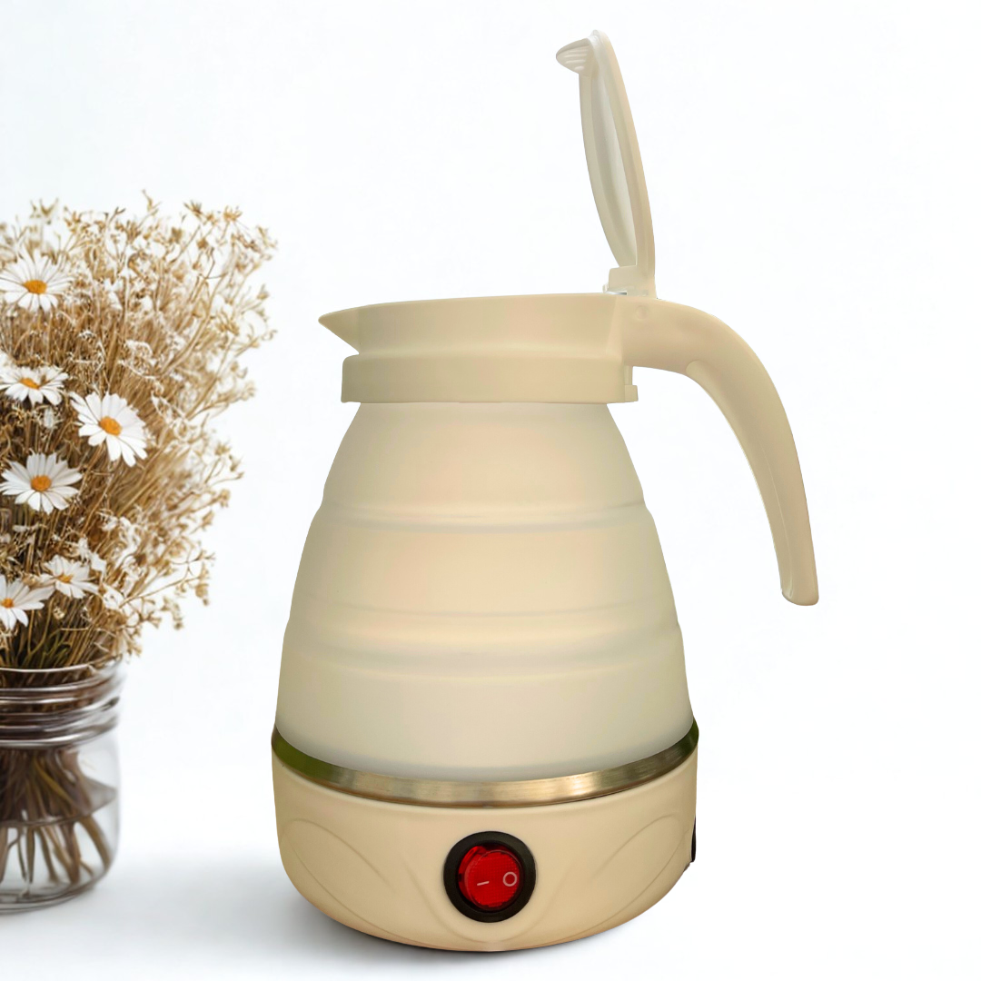 White electric kettle with a red light on a white background