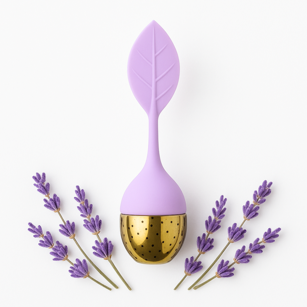 Purple leaf-shaped tea infuser with gold interior, surrounded by lavender flowers on a white background