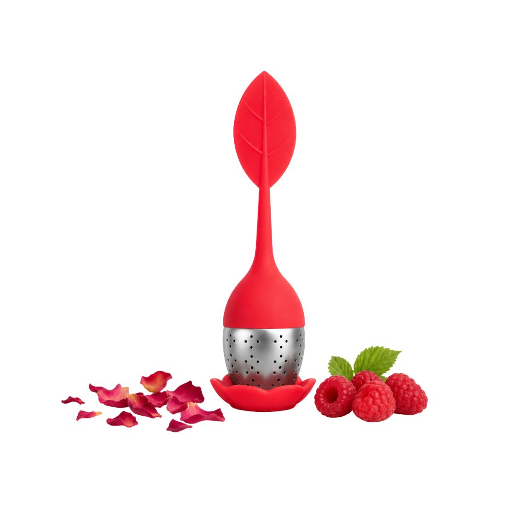 Red leaf-shaped tea infuser with silver mesh and decorative elements on a white background