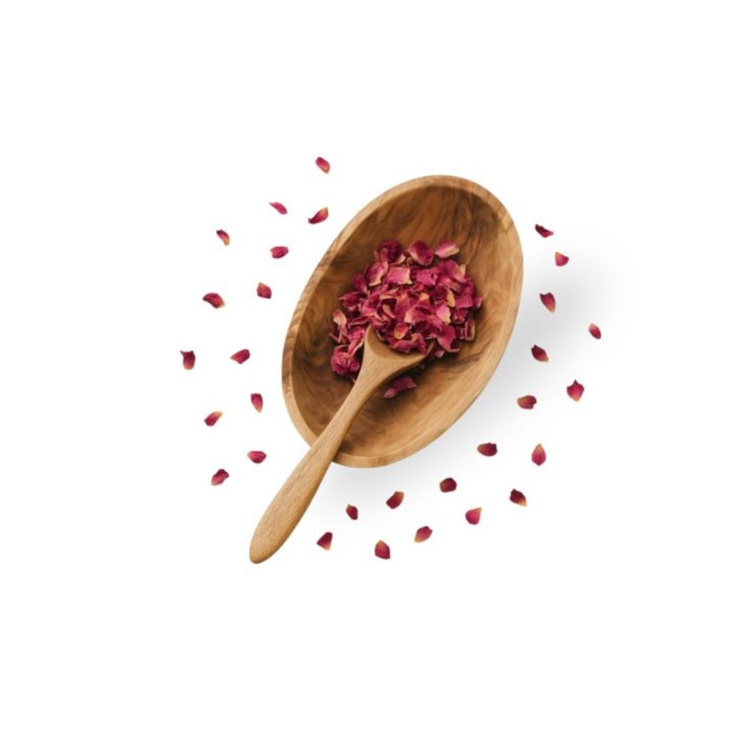 Wooden spoon with red rose petals on a white background