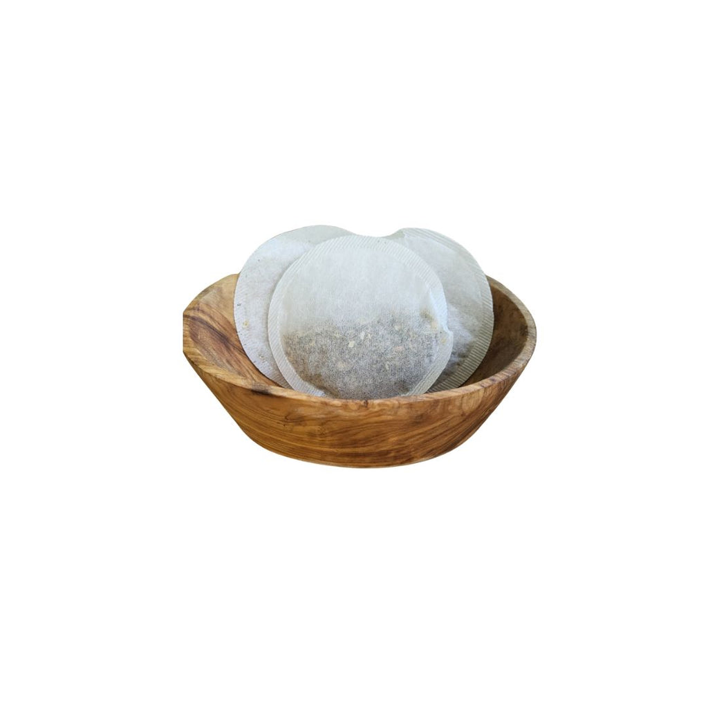 Wooden bowl with white circular items on a white background