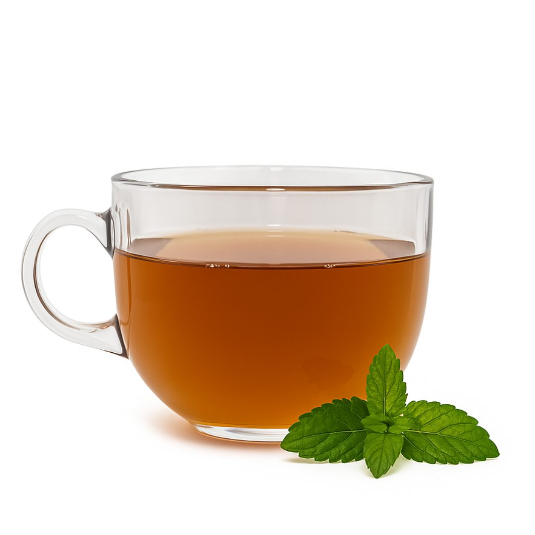 Clear glass mug filled with tea and a sprig of mint on a white background
