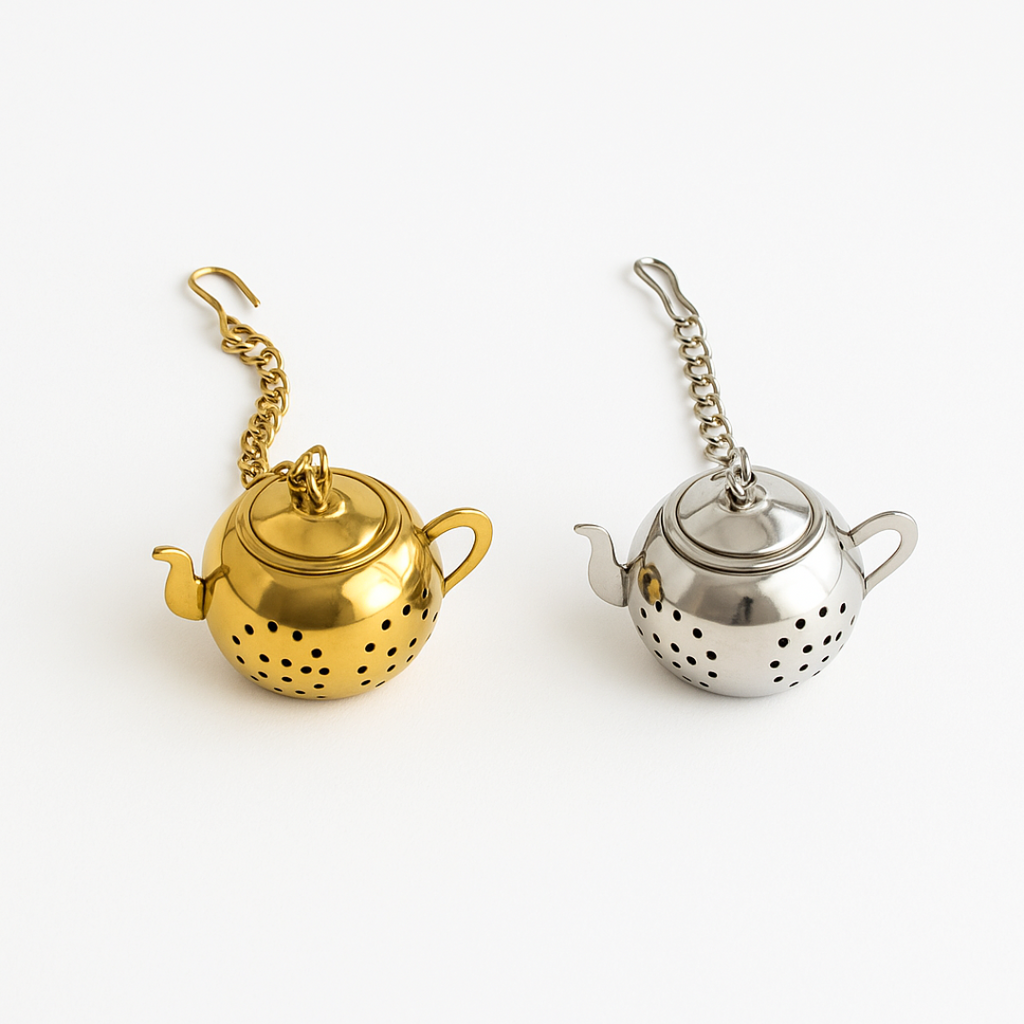 Gold and silver tea infusers on a white background