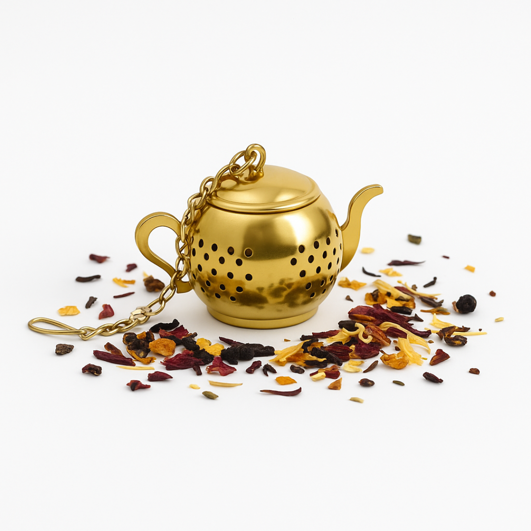 Gold tea infuser with dried herbs on a white background