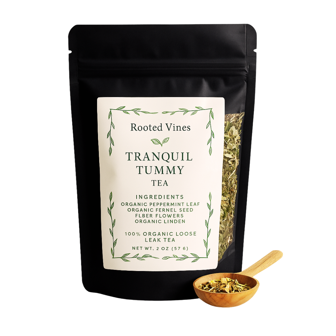 Tea package labeled 'Tranquil Tummy Tea' by Rooted Vines with a wooden scoop of tea leaves.