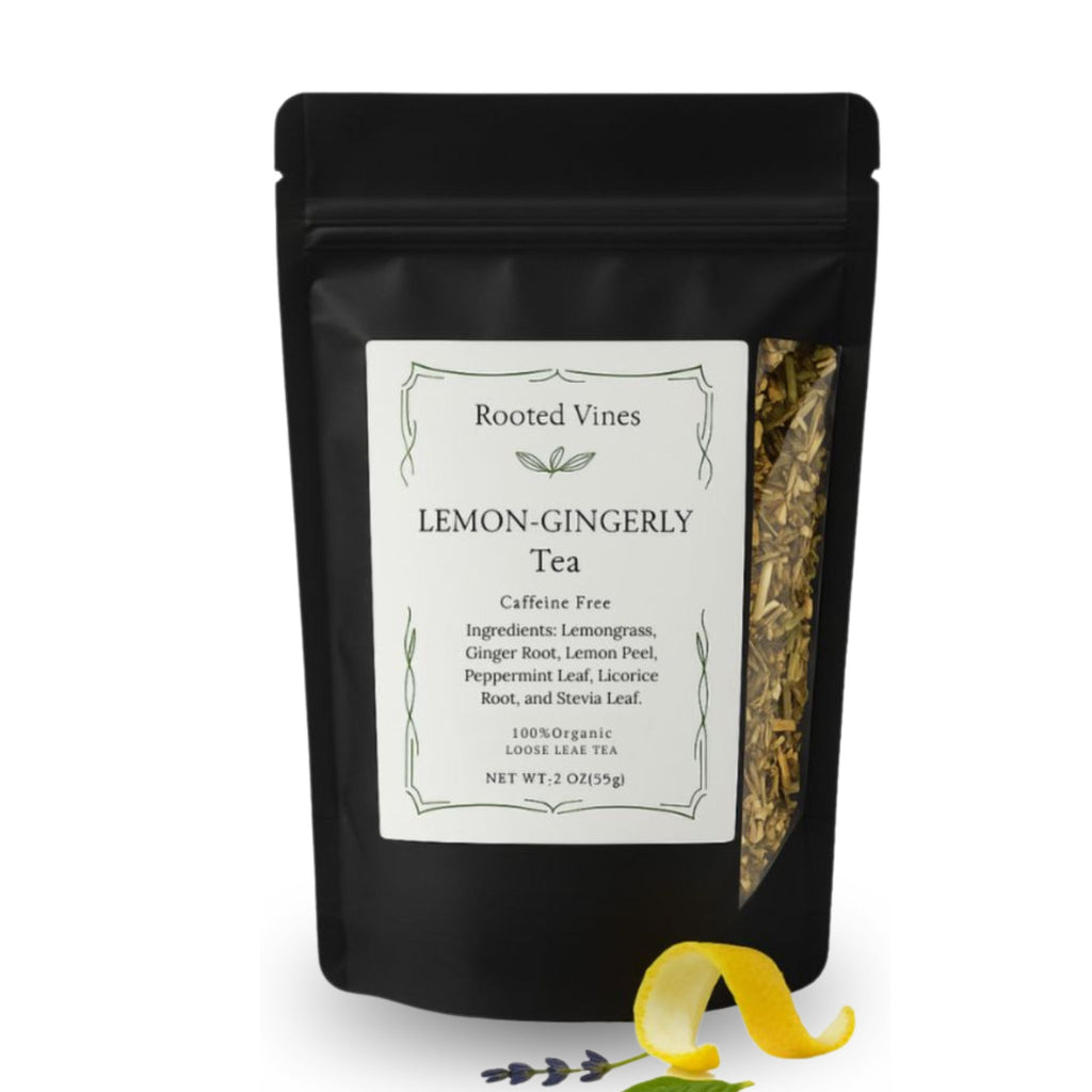 A black stand-up pouch of Rooted Vines Lemon-Gingerly Tea on a white background, with a white front label and a clear side window showing loose tea leaves. A yellow lemon slice and small green herbs are placed in front of the pouch.