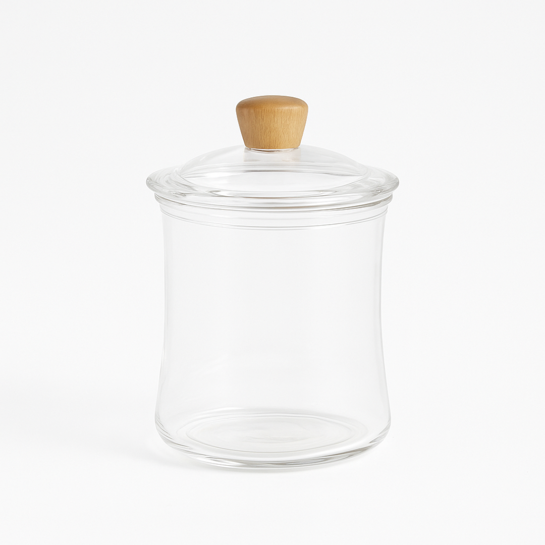 Clear glass jar with a wooden lid on a white background