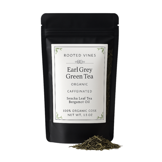 Black package of Rooted Vines Earl Grey Green Tea with loose tea leaves on a white background