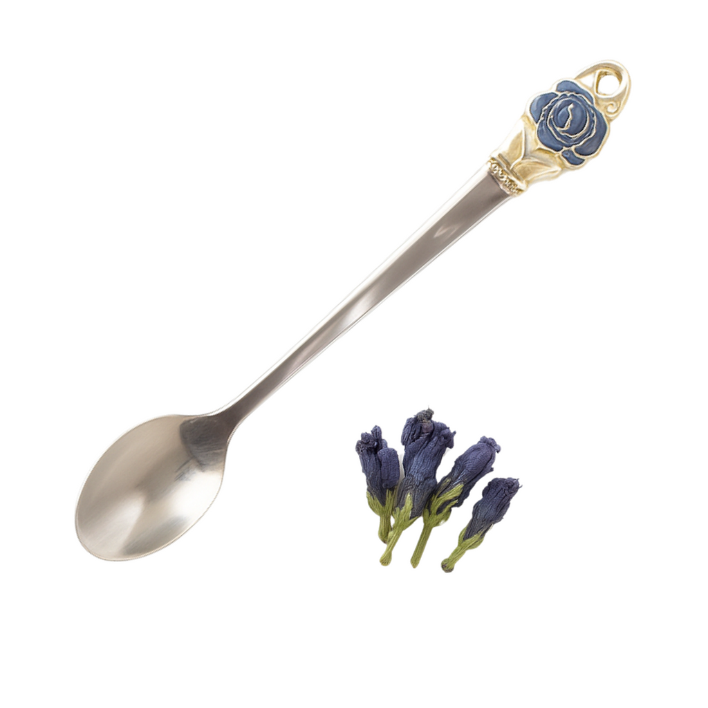 Decorative spoon with a rose emblem next to dried lavender flowers on a white background