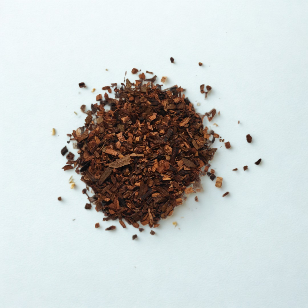 Dried brown herbs or spices on a white background