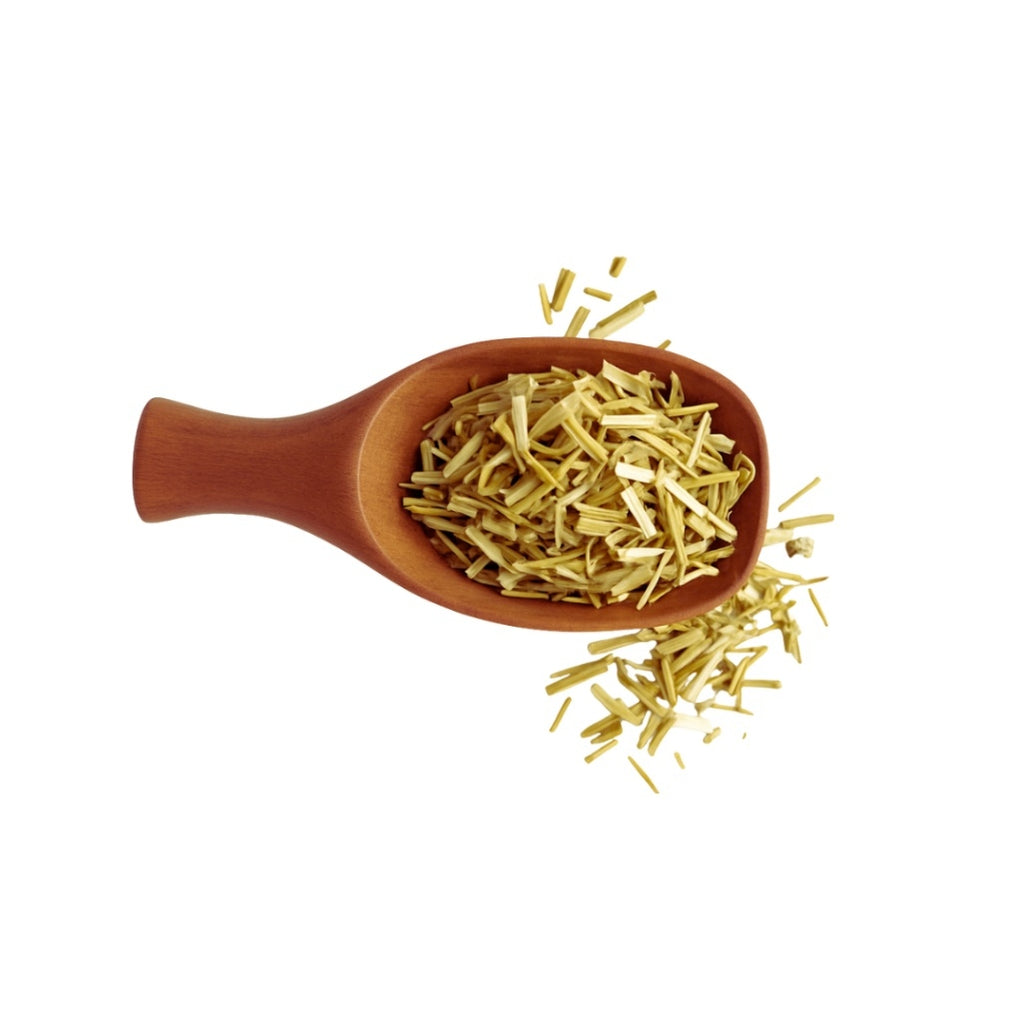 Wooden spoon filled with dried herbs on a white background
